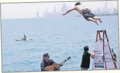  ?? Picture: (AP Photo/Shafkat Anowar) ?? Dan O’Conor, the ‘Great Lake Jumper’, makes his 365th leap into Lake Michigan, Saturday, June 12, 2021, in Chicago’s Montrose Point.