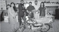  ?? -APP ?? Manager Serena Hotel Mehak Malik awarding prize of motorbike to a winner guest through balloting during Special Iftar/Dinner Buffet arranged by the hotel in the holy month of Ramzan.