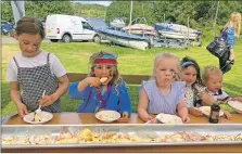  ?? ?? A several-metres-long banana split was enjoyed by Sophia Naylor, Maya Nef Lowrie, Lucy Philip, Jenna Oswald and Max Philip.