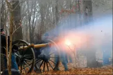 ?? File photograph ?? Members of the First Iowa Artillery fired their cannons during a previous event from the exact site where they were located in the actual Battle of Pea Ridge. The gun position was about 200 yards from the Elk Horn Tavern in the Pea Ridge National Military Park.