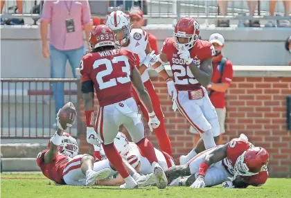  ?? BRYAN TERRY/THE OKLAHOMAN ?? OU's D.J. Graham holds up the football after an intercepti­on in the fourth quarter of a 23-16 win against Nebraska on Saturday at Gaylord Family-Oklahoma Memorial Stadium in Norman.