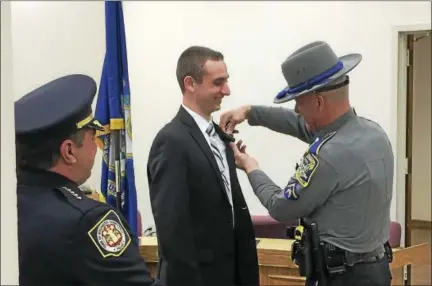  ?? BEN LAMBERT — THE REGISTER CITIZEN ?? Brandon Simmons, 21, of Woodbury, was sworn in as the newest member of the Winsted Police Department Wednesday.