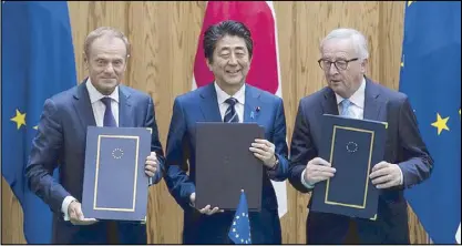  ??  ?? Japanese Prime Minister Shinzo Abe (center), European Union Council president Donald Tusk (left) and European Union Commission president Jean Claude-Juncker pose after signing a contract at the Prime Minister’s office in Tokyo.