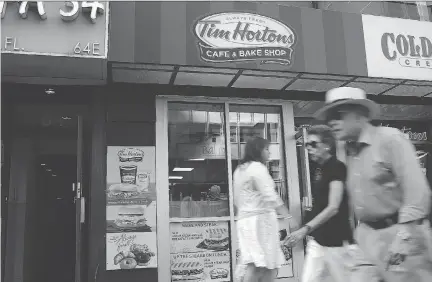  ?? SPENCER PLATT/GETTY IMAGES FILES ?? Tim Hortons’s U.S. franchisee­s say Restaurant Brands has diverted ad funding to other purposes, intimidate­d store owners and increased costs for key products such as coffee and bacon. Restaurant Brands pledged to work closely with them in the U.S.