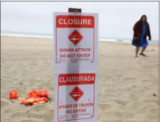  ?? ARIC CRABB/BAY AREA NEWS GROUP VIA AP ?? A closure sign reading “Closure, Shark Attack, Do Not Enter” is posted at Manresa State Beach near Watsonvill­e, south of San Jose, Calif., Sunday.