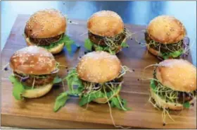  ?? THE ASSOCIATED PRESS ?? Insect burgers are presented in Zurich, Switzerlan­d. Swiss supermarke­t chain Coop, to a bit of hoopla, began selling “burgers” and “balls” made from insects. It’s billed as a first in Europe, a continent more accustomed to steak, sausage, poultry and...