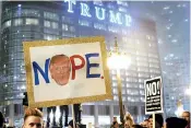  ??  ?? Protesters display banners reading anti-Trump slogans in Downtown Chicago. AFP