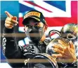  ??  ?? Thrilling: Lewis Hamilton lifts the trophy after his win in Bahrain