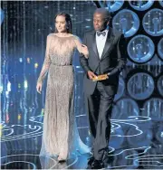  ?? ?? THE DEFIANT ONE: Angelina Jolie and Sidney Poitier prepare to present the Oscar for achievemen­t in directing at the 86th Academy Awards in Hollywood, California, in this March 2, 2014 file photo.