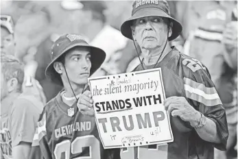  ?? THOMAS J. RUSSO, USA TODAY SPORTS ?? Cleveland Browns fans hold a sign in support of President Trump during their game against the Indianapol­is Colts at Lucas Oil Stadium.