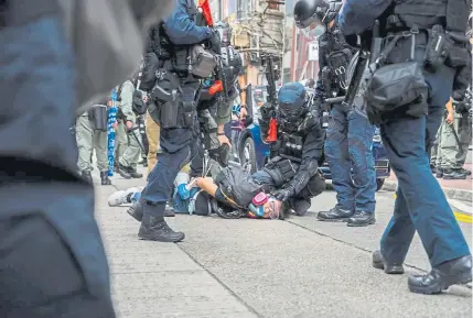  ?? Billy H.C. Kwok, Getty Images ?? A democracy supporter is detained by police during a protest of the Chinese government on Sunday in Hong Kong.