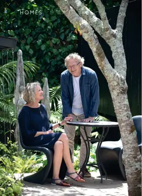  ??  ?? THIS PAGE (from top) Lorraine and Roger at the table and chairs at the back of their garden; the stone sculptures are by Rebecca Rose. The fencing was chosen because it takes up less space than a traditiona­l hedge; it will eventually be covered in...