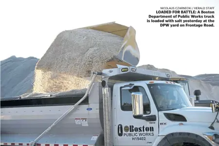  ?? NICOLAUS CZARNECKI / HERALD STAFF ?? LOADED FOR BATTLE: A Boston Department of Public Works truck is loaded with salt yesterday at the DPW yard on Frontage Road.