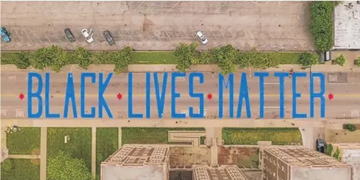  ?? ALEJANDRO REYES/PROVIDED PHOTO ?? Chicago’s first “Black Lives Matter” street mural, seen here from a drone flying over Jeffery Boulevard in South Shore, plays off the image of the city’s flag.