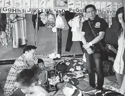  ??  ?? CARING FOR MAYON EVACUEES – Presidenti­al Political Adviser Secretary Francis N. Tolentino (seated) talks to a child evacuee in Camalig, Albay, as Health officials look on. Tolentino, the current Mayon Volcano crisis manager, has been overseeing...