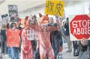  ??  ?? LEFT Animal rights protesters march to the Hong Kong Internatio­nal Fur and Fashion Fair in February calling on the Hong Kong government to legislate on a fur trade ban.