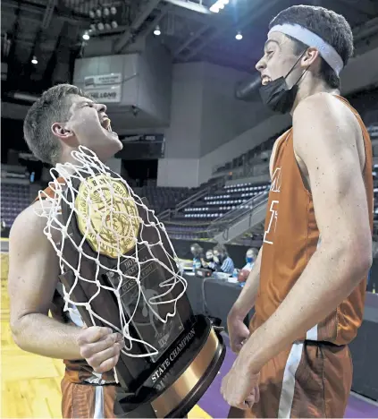  ?? Helen H. Richardson, The Denver Post ?? Mead teammates Jason Pelzel, left, and JP Shiers, right, celebrate with the state championsh­ip trophy after winning the Class 4A boys state championsh­ips at the Broadmoor World Arena on Sunday in Colorado Springs.