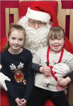  ??  ?? Ailbhe and Zoe O’Hanlon visiting Santa at the Christmas gift fair at Coláiste Chraobh Abhann in Kilcoole