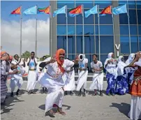  ?? — AFP ?? Somalis dance as they wait for the arrival of Eritrea’s President at Aden Abdulle airport in Mogadishu on Thursday.