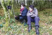  ??  ?? ABOVE INSET In Coed Abergarfan woods near her Snowdonia home, Julie (right) reviews footage from a camera trap with VWT project officer Josie Bridges