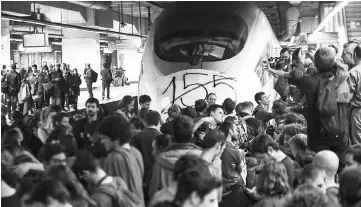  ??  ?? Protesters block the tracks of the high speed train AVE in Sants train station during a partial regional strike in Barcelona, Spain. — Reuters photo