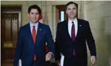  ?? SEAN KILPATRICK/THE CANADIAN PRESS FILE PHOTO ?? Prime Minister Justin Trudeau and Finance Minister Bill Morneau are reserving judgment on how Trump’s policies might affect the economy.