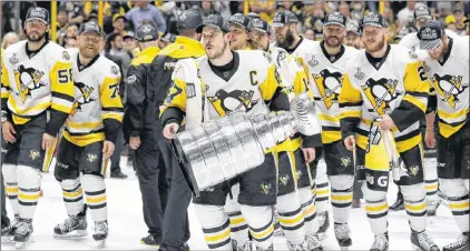  ?? AP PHOTO ?? In this June 11 photo, Pittsburgh Penguins’ Sidney Crosby (87) celebrates with the Stanley Cup after defeating the Nashville Predators in Game 6 of the NHL Stanley Cup Final in Nashville, Tenn.