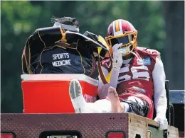  ?? PATRICK SEMANSKY/ASSOCIATED PRESS FILE ?? Redskins linebacker Reuben Foster rides a cart off the field after suffering an injury during a practice May 20. The NFL wants to reduce lower-body injuries as well as concussion­s.