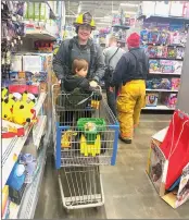  ?? Photo by Beth Koop ?? For the first time this year, local fire department­s helped children shop during Shop with a First Responder at Walmart in St. Marys on Wednesday evening.