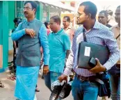  ?? — AGENCIES ?? Union minister’s personal assistant carrying his shoes in Odisha on Monday.