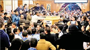  ??  ?? Egyptians gather during the funeral of the victims of the attack on the Saint Mina Coptic church. — AFP photo