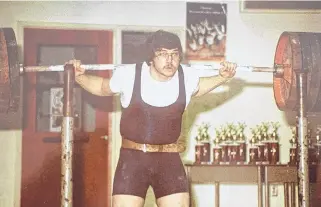  ??  ?? Glen Hutchison competes n a powerlifti­ng event early in his 45-year career in the sport.