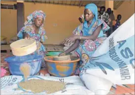  ??  ?? Women power: Tenning Ngom, 27, (left) sifts millet. She also has a food stall, thanks to funds from a women’s associatio­n. Photo: AFP/ Seyllou
