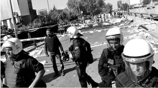  ??  ?? Police forensic experts examine the scene following explosions during a peace march in Ankara