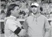  ?? [SARAH PHIPPS/ THE OKLAHOMAN] ?? OSU coach Mike Gundy, left, talks with OU coach Lincoln Riley before last season's Bedlam football game in Stillwater. The Sooners host the Cowboys at 6:30 p.m. Saturday in Norman.