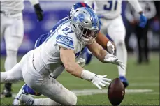  ?? ADAM HUNGER — THE ASSOCIATED PRESS ?? Detroit Lions defensive end Aidan Hutchinson (97) recovers a fumble by New York Giants wide receiver Isaiah Hodgins (18) during last month’s game in East Rutherford, N.J.