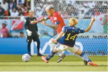  ?? Korea Times photo by Choi Won-suk ?? Costa Rica’s Francisco Calvo, rear, dribbles past Japan’s Junya Ito during the 2022 Qatar World Cup group stage match at Ahmad Bin Ali Stadium in Al Rayyan, Sunday.