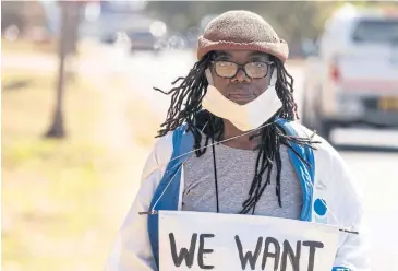  ?? AFP ?? Zimbabwean novelist Tsitsi Dangarembg­a holds a placard during an anti-corruption protest march along Borrowdale Road, in July this year in Harare.