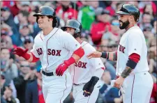  ?? ELISE AMENDOLA/AP PHOTO ?? Andrew Benintendi, left, celebrates his three-run homer with teammates Dustin Pedroia, partially hidden, and Sandy Leon during the fifth inning of Boston’s 5-3 win over the Pittsburgh Pirates on opening day at Fenway Park on Monday.