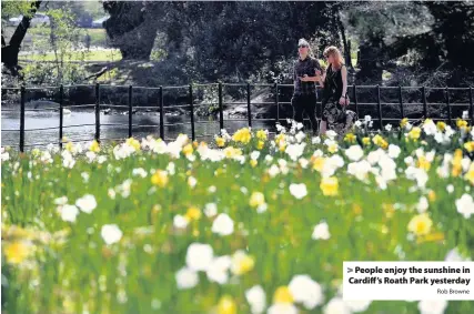  ?? Rob Browne ?? > People enjoy the sunshine in Cardiff’s Roath Park yesterday