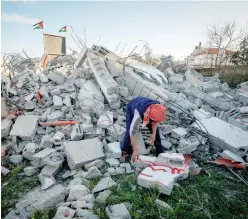  ?? (Flash90) ?? A MAN walks past the rubble of the family house of Palestinia­n terrorist Yazen Hassin Hassni Mjames in Bir Zeit yesterday after it was demolished by the IDF.