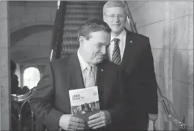  ?? PATRICK DOYLE  REUTERS ?? Jim Flaherty (left) and Stephen Harper are smiling because their budget will trim billions in government spending with OAS reforms and greater pension contributi­ons by public servants.