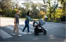  ?? PHOTO BY DON FERIA ?? Tanya Chantara and Robert Surrency take their daughter Chloe,
1, for an outing at Golden Gate Park on Nov. 11. He moved to Alaska, but came back.