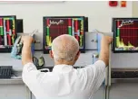  ??  ?? An investor looks at screens showing stock market movements at a securities company in Fuyang in China’s eastern Anhui province. —AFP