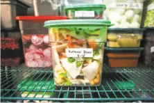  ??  ?? Slaw that was made from produce that was ordered with the BlueCart app is kept in the walk-in refrigerat­or at Per Diem.