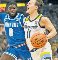  ?? Getty Images ?? STRONG ‘D’: Dylan Addae-Wusu, left, and Seton Hall held Marquette star Tyler Kolek — last year’s Big East player of the year — to four points Saturday.