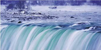  ?? AARON LYNETT, THE CANADIAN PRESS ?? Mist rises around an old barge in the upper Niagara River near the brink of the falls in Niagara Falls, Ont., on Friday as cold weather continued to engulf much of Canada.