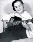  ??  ?? Joe Negri at age 8 with his first guitar, an Epiphone. His father liked him and his brother, Bobby, to wear berets when they performed as the Rhythm Boys.