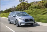  ?? THE ASSOCIATED PRESS PHOTO VIA TOYOTA MOTOR SALES USA AND HONDA ?? The 2021 Toyota Sienna Platinum hybrid minivan, left, and the 2021 Honda Odyssey.