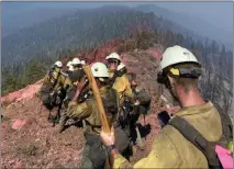  ?? US FOREST SERVICE — NATIONAL PARK SERVICE ?? The Breckenrid­ge Hot Shot Crew, from Kern County, hikes down a ridge during the Washburn Fire, which was burning in Sequoia National Forest and the southern part of Yosemite National Park.